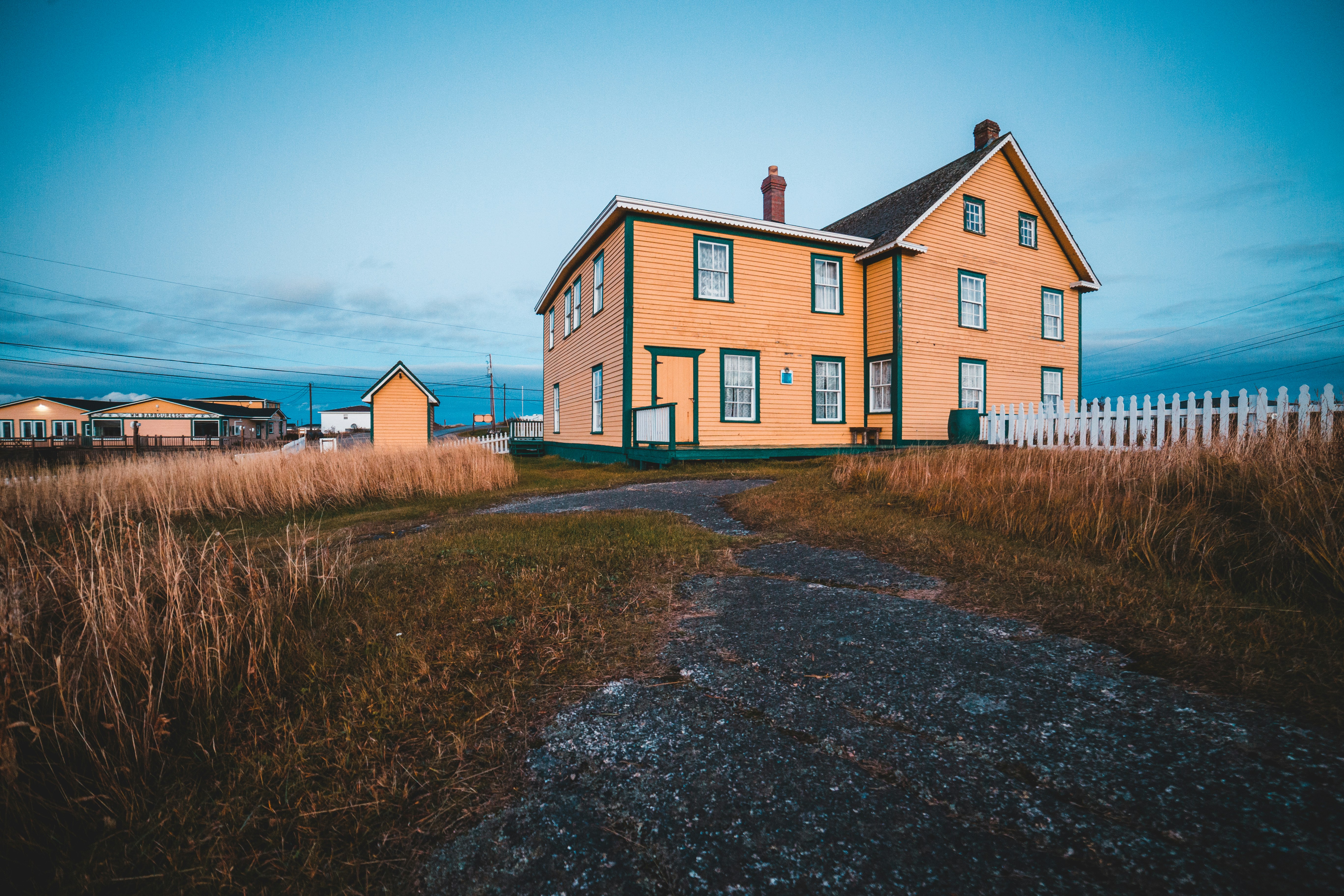 brown wooden house surrounded with green grass